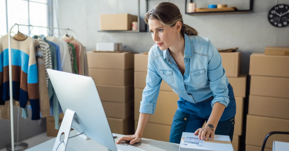 Clothing founder preparing orders at her studio desk